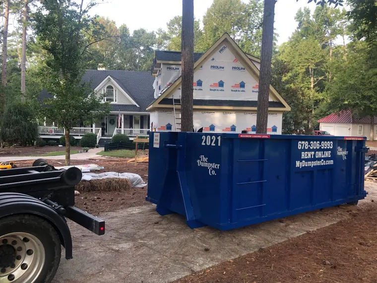 The Dumpster Co. roll-off dumpster at a home under renovation
