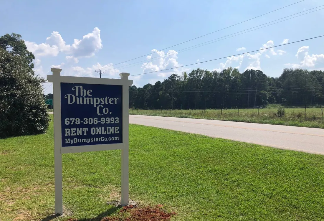 The Dumpster Co. roadside sign with phone number and website in Jackson, GA